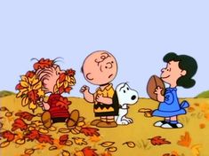 charlie brown and his friends are playing with leaves on the ground in front of an autumn scene