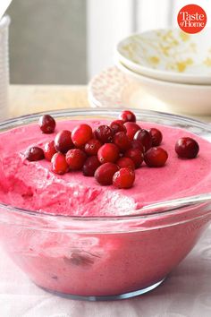 a bowl filled with cranberry cheesecake on top of a table