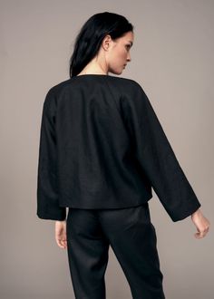 Both black and linen are unexpected choices for a jacket, but the IRA LYSA Barbera Jacket will become your go-to for unexpected spring and summer nights. Sleeves rolled up or down, buttoned or unbuttoned, belted or not - the choice is yours. * A-line jacket* Pockets* One decorative snap* Round neckline* Raglan sleeves* Cropped sleeves Material: 100% European linen, silk lining Handmade. Always. Chic Black Blazer With Belted Cuffs, Black Cropped Jacket For Spring Workwear, Black Blazer With Belted Cuffs And Long Sleeves, Belted Linen Outerwear For Fall, Fall Linen Belted Outerwear, Long Sleeve Belted Linen Outerwear, Spring Linen Belted Outerwear, Belted Long Sleeve Linen Outerwear, Black Linen Outerwear For Fall