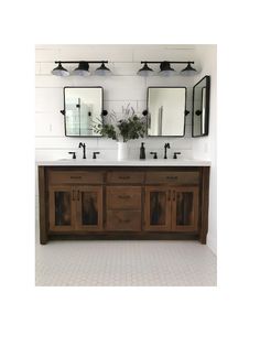 a bathroom with two sinks and mirrors on the wall