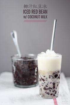 two glasses filled with ice cream and chocolate chip cookie milkshakes on top of a table