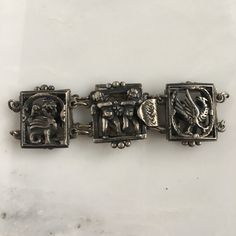 Details: Lovely 1940's Italian theme sterling bracelet. Images of Angels and birds (possibly phenix) grace this sweet bracelet. Would make a lovely gift! The bracelet is stamped Sterling on the inside of the clasp. Please ask all necessary questions prior to placing an order. Measurements: The bracelet measures 6 1/2 inches. The width of the bracelet is 3/4 inch. Condition: The overall all condition of this bracelet is very good. Antique Sterling Silver Bracelets, Antique Engraved Bracelets For Gifts, Victorian Sterling Silver Bracelets In Antique Silver, Antique Silver Bracelet Gift, Antique Silver Nickel-free Bracelets, Ornate Stamped Bracelets For Gift, Antique Sterling Silver Clasp Bracelet For Formal Occasions, Antique Bracelets With Sterling Silver Clasp For Formal Occasions, Antique Bracelet With Sterling Silver Clasp For Formal Occasions