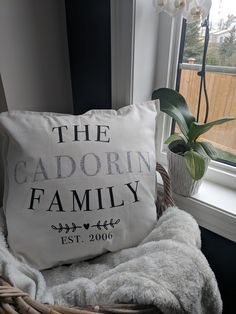 a white pillow sitting on top of a chair next to a window