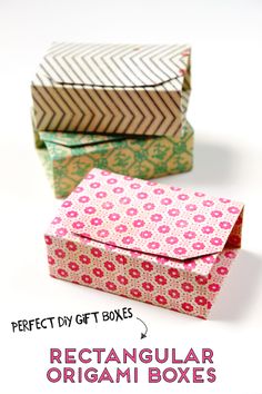 three folded boxes with different patterns on them, one is pink and the other is green