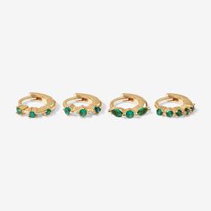 Make these colorful huggie earrings’ your new timeless treasures. Roland's delicate design, with feature emerald crystal detailing, will bring just the right amount of luxe to any ensemble. Perfect for stacking with more huggies, studs or ear cuffs. Created for you with a sterling silver base and utilizing an extra luxurious 14 karat gold plating, this earring set is everything you love about our demi-fine jewelry collection. Model is wearing Roland in her helix. Green Huggie Earrings With Matching Set, Green Gemstone Huggie Earrings, Emerald Huggie Earrings For May Birthstone, Green Emerald Huggie Earrings, Green Huggie Earrings For May Birthstone, Emerald Earring, Piercings Ear, Earrings Piercings, Emerald Crystal