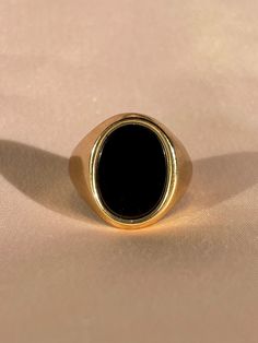 "Vintage 9k yellow gold impressive onyx signet ring from Birmingham, England c 1972. Excellent vintage condition Size: 9.5 resizable* Weight: 6.7 grams Band: 19.2 mm (front), 4.0 mm (back) Onyx: 15.0 mm x 11.3 mm x oval cut Hallmarks: 375 for 9k, anchor for Birmingham, \"X\" for 1972 Please note, vintage and antique jewelry may come with imperfections commensurate of their age. To see more photos and videos of this piece, visit our Instagram: www.instagram.com/23carat PLEASE READ ALL POLICIES re Classic Black Signet Ring For Formal Occasions, Black Oval Signet Ring For Formal Occasion, Classic Black Enamel Signet Ring For Formal Occasions, Classic Round Signet Ring With Black Enamel, Gold Signet Ring With Black Enamel For Formal Occasions, Timeless Black Enamel Signet Ring For Formal Occasions, Vintage Black Round Signet Ring, Formal Black 14k Stamped Signet Ring, Vintage Black Signet Ring Stamped 14k