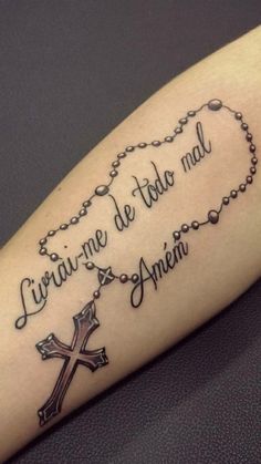 a tattoo with the words written on it and a rosary in the shape of a heart