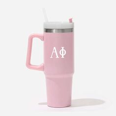 a pink travel mug with the letter a on it and a straw in its mouth