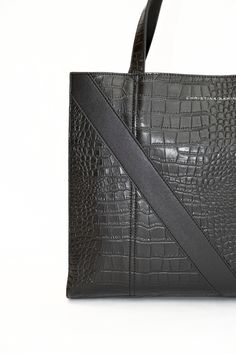 A Christina Karin Exclusive - The Marais Python Tote Inspired by Paris' fashion focused Le Marais district, this python leather tote bag combines modern architectural details with textural intrigue. Generous carry all sizing allows it to fit all your essentials and then some. Make it your travel partner or pair it with a power suit for ease and sophistication. We've designed this tote to go the distance in every modern woman's real life. We invite you to discover the essence of everyday luxury. Designer Square Bag In Textured Leather, Designer Square Bags In Textured Leather, Designer Textured Leather Square Bags, Designer Square Textured Leather Bag, Modern Structured Bags With Handles, Modern Structured Bag With Handles, Designer Structured Shopping Bags, Luxury Structured Shoulder Bag For Shopping, Structured Textured Leather Shopping Bags