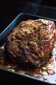 a piece of meat is being cooked on a grill