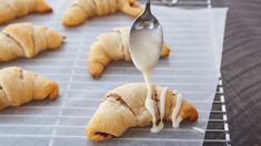 croissants are being prepared and drizzled with icing