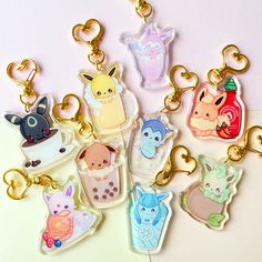 the keychains are shaped like cartoon animals and have different designs on them,