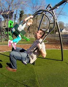 a father and his daughter playing in the park