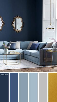 a living room with blue walls and gold accents in the color scheme, along with two mirrors on the wall