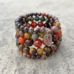 Earth tones of green, brown, red and orange define this 5 wrap boho bracelet.Genuine semi-precious stones featuring Tiger's Eye, Jasper, and Crackle Agate make up this done-for-you stack. 4mm round jasper 8mm Tiger's Eye 10mm faceted Crackle Agate one size fits most - best for small to medium wrists Handmade in Lincoln, Nebraska Earthy Style Wrap Bracelet With Round Beads For Gift, Multicolor Wrap Bracelet With Round Beads And Natural Stones, Bohemian Wrap Bracelet With Round Beads For Meditation, Multicolor Gemstone Beads Wrap Bracelet For Healing, Spiritual Wrap Bracelet With Round Bead Natural Stones, Spiritual Round Beads Bracelets For Layering, Spiritual Wrap Bracelet With Round Natural Stones, Bohemian Brown Agate Beaded Bracelets, Earthy Multicolor Beaded Bracelets For Meditation