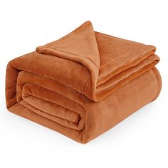 an orange blanket folded on top of each other