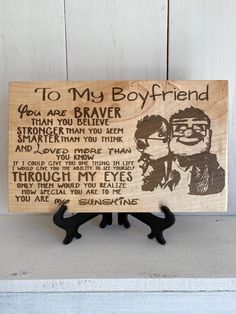 a wooden plaque with the words to my boyfriend on it and an image of two men