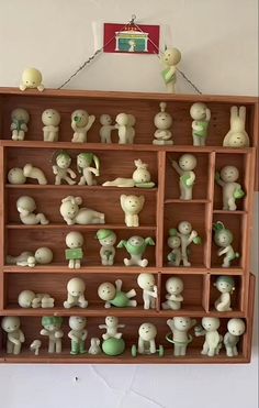 a wooden shelf filled with lots of small figurines