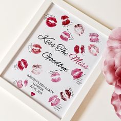 a white frame with pink flowers and lipstick on it