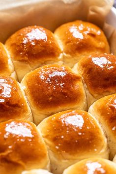 freshly baked bread rolls in a baking pan with sugar on top, ready to be eaten