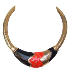 Sleek black & red enamel gilt metal choker style necklace c 1980 The stylish necklace is designed with a bold abstract center plaque The red & black enamel is juxtaposed with gilt metal accents The necklace transitions into wide gilt metal coiled bands that contour around the neck Makes a striking bold accessory The necklace is unsigned The necklace length measures 16" 1/2 inches The enamel center plaque measures 1" inch wide at the widest point Red Choker Necklace, Necklaces Red, Red Choker, Necklace C, Metal Choker, Choker Jewelry, Choker Style Necklace, Bold Accessories, Stylish Necklace