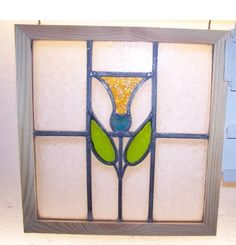 a stained glass window with a green flower in the center and number 5 on it