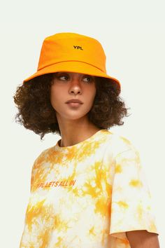 Stay protected from the sun's harmful UV rays with the YPL Fisherman's Cap. This double-sided design features a wide brim to offer maximum coverage, while the specially designed fabric reduces UV penetration for a safer outdoor experience. Yoga Set, Sweater Coats, Wide Brimmed, Uv Rays, Bra Tops, Dress Accessories, Orange Color, Design Features, Hoodie Shirt