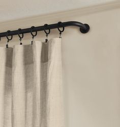 a curtain with black metal rods hanging from it's side