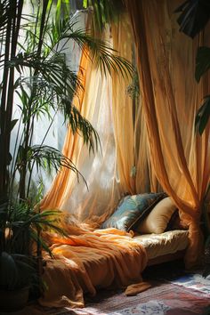 a bed covered in yellow curtains next to potted plants