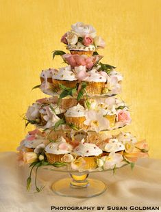 a cake with cupcakes and flowers on it