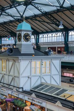 a clock tower in the middle of a train station