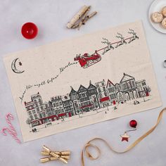 a christmas card with a santa sleigh flying in the sky over a town