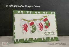 a christmas card with stockings and stockings hanging from a line on the side, next to a