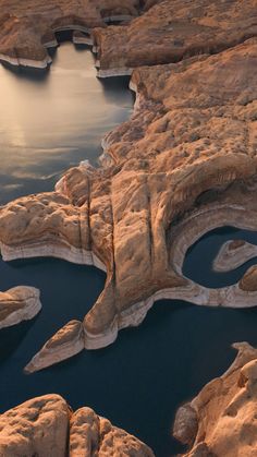 an aerial view of some water and rocks in the desert, looking down on it