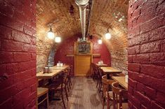 the interior of a brick restaurant with tables and chairs