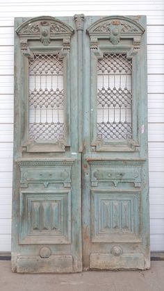 an old pair of wooden doors sitting next to each other