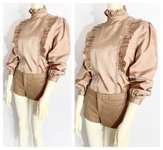 Vintage Ruffle Front Long Sleeve Tan Blouse / size Small-Medium ... *fabric unknown/unmarked. *sandy tan silk or silk-like fabric with slight sheen *high-collared, asymmetrical button front blouse with ruffle-front design *long sleeves with gathered-puff shoulders and gathered, buttoned sleeve cuffs *ruffled collar, cuff and bodice  *very, 1980s new-romantic, Princess Di Sloane Ranger meets 2024 Twee + Coquette mash-up.  *great vintage condition  LABEL : Good Year FABRIC : fabric unknown.  FIT: Sloane Ranger, Romantic Princess, Tan Silk, Tan Blouse, Good Year, Ruffled Collar, Small Dress, Dress Form, Front Design