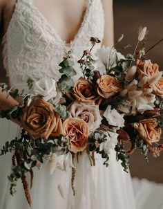 a bride holding a bouquet of flowers in her hands