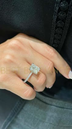 a woman's hand with a diamond ring on it