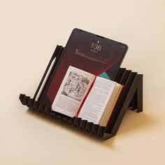 an open book sitting on top of a black holder