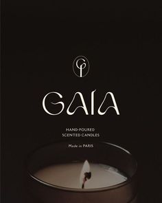 a candle with the word gaia written in white on it and an image of a candle