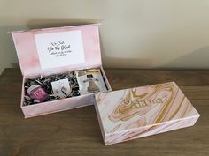 an open pink box with various items inside