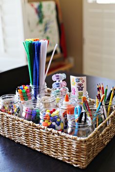 a basket filled with lots of craft supplies on top of a table