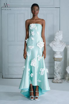 The dress is expertly designed to provide a flattering fit and elegant style for any special occasion. Made with high-quality taffeta and adorned with delicate flower appliques, this dress is sure to turn heads. Its strapless design and high-low hem add modern touches to the classic silhouette. Perfect for making a statement at weddings, proms, or any formal event. Modern Gown, High Low Gown, High Low Prom Dresses, Mean Blvd, Taffeta Dress, Figure Skating Dresses, Applique Dress, Fairy Dress, Flower Applique