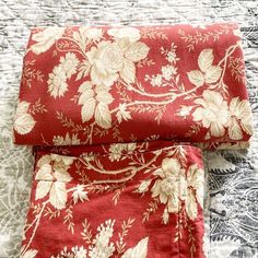 two pieces of red and white floral fabric