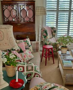 a living room filled with furniture and flowers