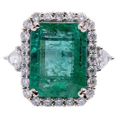 Elegant and classic gold ring with a dazzling emerald center stone accentuated by a natural earth mined diamond halo. Perfect for all occasions such as weddings, anniversaries, promise rings, birthdays, or just because! Specifications Item Type: Ring Center Stone: Emerald Treatment: Oiled Weight: 8.13ct Head size: 15x12mm Cut: Emerald Hardness: 7.5-8 Origin: Brazil Metal: 14k/5.72g Diamond Clarity/Color: SI / G-H Diamond Count/Weight: 26/1.39 cttw SKU: AJR912/25963 This ring is made with solid 14K Gold and natural Earth mined SI / G-H diamonds. As listed, this ring is ready to ship. If you're interested in purchasing this setting with a different center stone please message us! Classic Gold Rings, American Modern, Classic Gold, Natural Earth, Diamond Halo, Emerald Ring, Diamond Clarity, Cocktail Rings, Halo Diamond