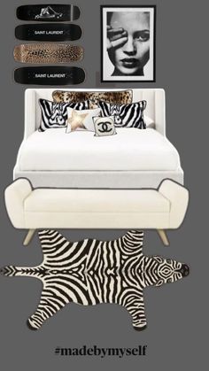 a white bed sitting next to a zebra rug and pictures on the wall above it