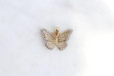 Give her the gift of wings with this beautiful butterfly necklace. DETAILS - 14k yellow gold butterfly with rhodium plating VARIATIONS If you require any variation of this style (a different style chain, longer chain, etc.) feel free to message us. We will do our best to accommodate you. Additional costs may apply depending on the variation. POLICY We do accept returns on this item minus a $25 restocking fee. Return shipping is the responsibility of the buyer. Any expedited shipping will not be Butterfly-shaped Yellow Gold Jewelry With Diamond Accents, Gold Butterfly Diamond Jewelry, Gold Diamond Butterfly Jewelry, 14k White Gold Butterfly Jewelry, 14k White Gold Butterfly-shaped Jewelry, Formal 14k Gold Butterfly Jewelry, 14k Gold Butterfly Jewelry For Formal Occasions, Butterfly Shaped Jewelry With Diamond Accents For Gifts, Elegant Butterfly Charms Jewelry