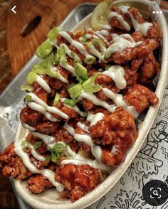 a platter filled with chicken covered in ranch dressing